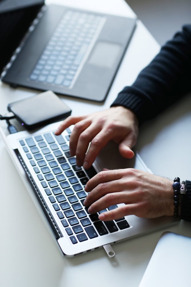 Focused Hands Typing on a Laptop