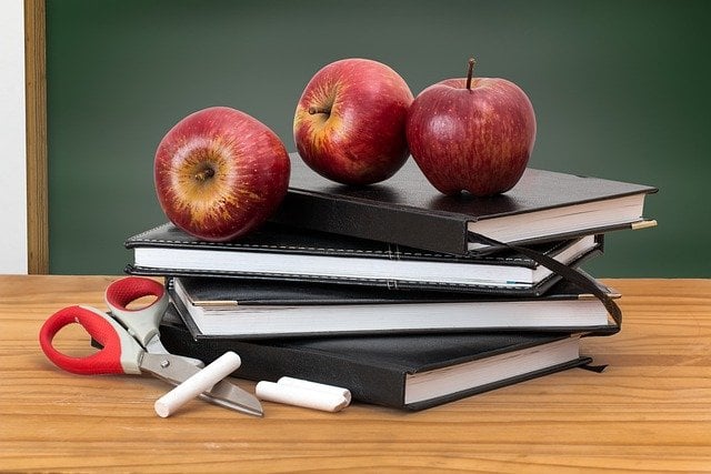 Fresh Apples on Stacked Notebooks